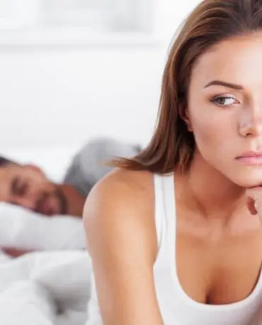 Canva - Woman in Deep Thought while Partner is Sleeping