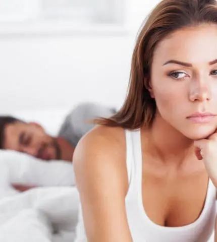 Canva - Woman in Deep Thought while Partner is Sleeping